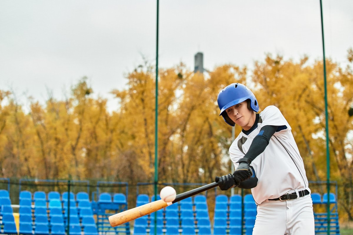 A talented baseball player focuses on his swing while playing baseball during practice in fall